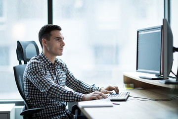 Portrait of young businessman working on computer