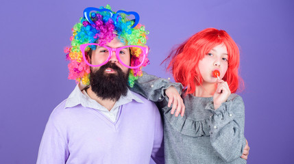 How crazy is your father. Man bearded father and girl wear colorful wig while eat lollipop candy. Thing loving father do for children. Tribute to fun dad. Easy simple ways be fun playful parent
