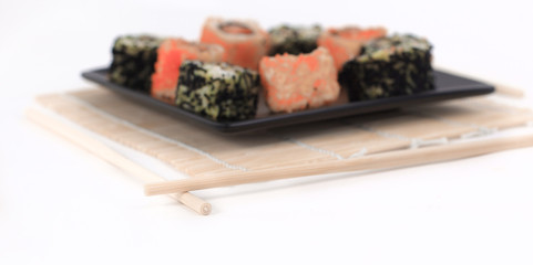 different types of Maki sushi on a black plate