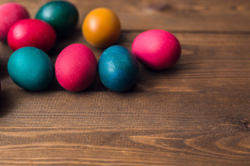 Fototapeta na wymiar Colorful Easter eggs on dark wooden table
