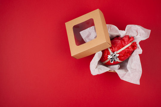 Gift box with the realistic heart inside as a gift