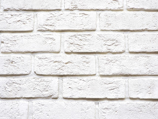 Background and texture of white tiles for facing the facade of the building in the form of bricks..