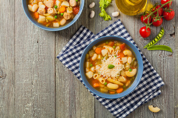 Minestrone soup with pasta and cheese or crostini.