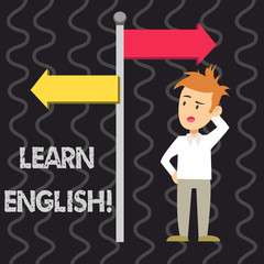 Writing note showing Learn English. Business concept for gain acquire knowledge in new language by study Man Confused with Road Sign Pointing to Opposite Direction