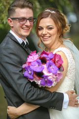 Beautiful wedding couple posing in park