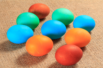 Painted eggs on sackcloth as a background.