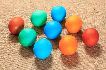 Painted eggs on sackcloth as a background.