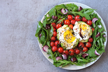 Colorful plate with healthy food. Salad with arugula, avocado, egg and cherry tomatoes. Keto diet. Keto lunch