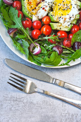 Colorful plate with healthy food. Salad with arugula, avocado, egg and cherry tomatoes. Keto diet. Keto lunch