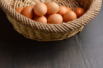 Stack of brown eggs in a wicker basket