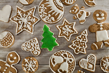 Christmas gingerbread on a light wooden table. A Symbol Of Christmas. Festive food. Delicious cookies and gingerbread. The gingerbread man. Table decoration for the holiday.