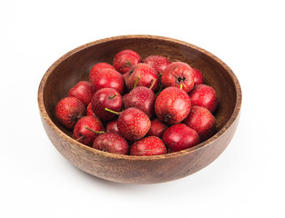 fresh hawthorns in a wooden bowl