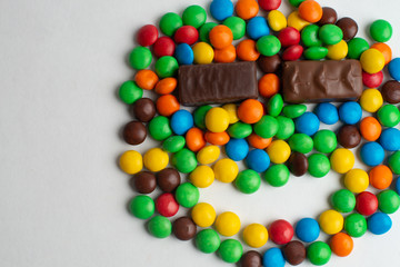 Colorful chocolate candies on the white background