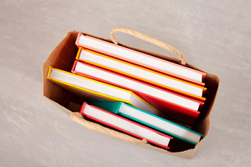 Colorful books in the shopping bag