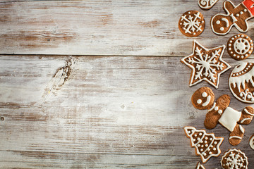 Christmas gingerbread on a light wooden table. A Symbol Of Christmas. Festive food. Delicious cookies and gingerbread. The gingerbread man. Table decoration for the holiday.