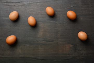 Group of eggs on the black wood background with copy space