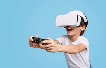 Excited kid in VR headset playing game 