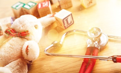 Stethoscope toys and box text on wooden table background.