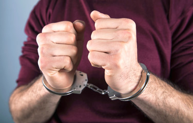 handcuffed man; prisoner