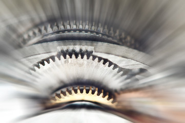 Metal Cogwheels in clock mechanism , abstract sun beams. Macro.