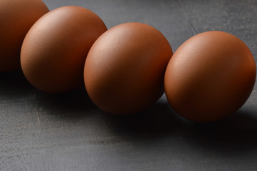 Group of eggs on the black wood background 
