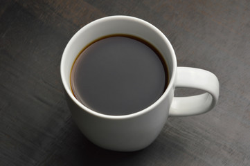Cup of coffee on black wood table