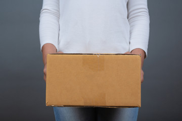 Woman holding a brown post box Made gestures with sign language.