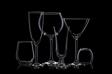 Glassware silhouettes on black.