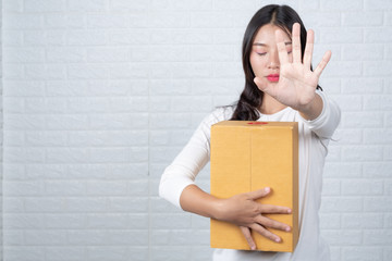 Woman holding a brown post box Made gestures with sign language.