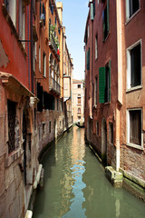 Fototapeta na wymiar Narrow streets, water canals and beautiful architecture in Venice, Italy