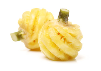 Ripe pineapple peeled on white background