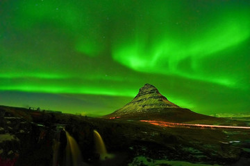View of the northern light at night at Kirkjufell Mountain in Iceland.