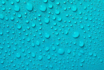Drops of water on a blue glass texture background