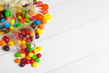 Bottles with sweet candies on table