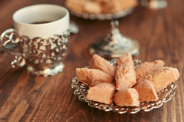Turkish sweets with coffee on a wooden table