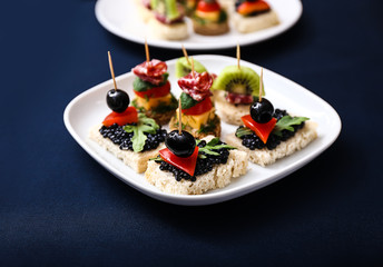 Tasty canapes on plate