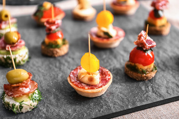 Tasty canapes on slate plate