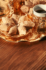 Fototapeta premium Turkish sweets with coffee on a wooden table