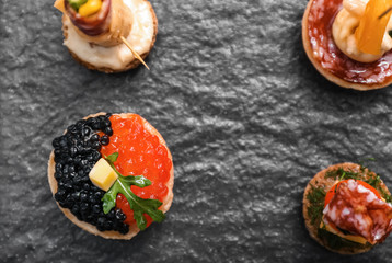 Tasty canapes on slate plate