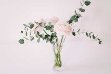 Pink ranunculus on white background. Romantic background for wedding invitations. Floral composition. Flatlay, copy space. 