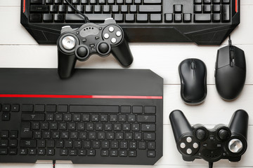 Modern gaming accessories on white wooden table
