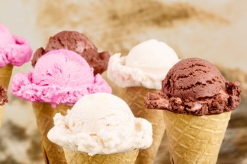 Ice cream scoops  with vanilla, chocolate and berry scoops and topping