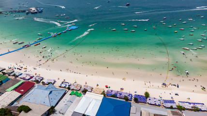 Aerial top view of beautiful tropical beach with white sand and turquoise clear water, Boat anchored in tawaen beach Ko Lan Chon Buri Thailand, Luxury yacht