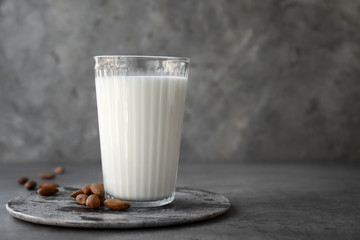 Glass of healthy almond milk on table