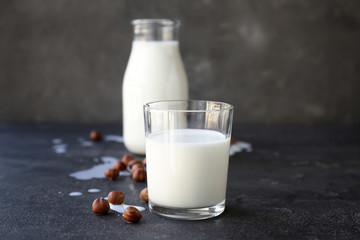 Glass of healthy hazelnut milk on table