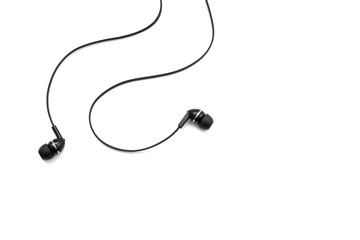 Headphones for listening music and sounds on portable devices on a white background. Ear plugs. Earflaps for a mobile phone. Headset from two earpieces. Playing music