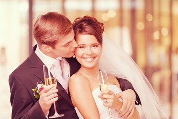 Young Wedding Couple Bride and Groom holding champagne glasses