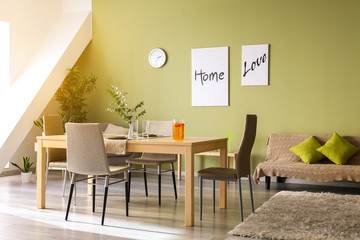 Stylish interior of dining room with served table