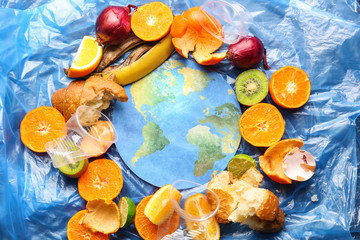 Paper figure of earth and garbage on polyethylene film. Concept of environmental protection