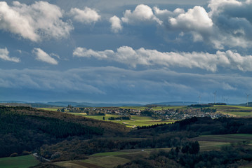 Fototapeta na wymiar View from the rock Rotenfels into the countryside in the surroundings of the town Bad Kreuznach and the village Feilbingert, Rhineland Palatinate (Germany) under beautiful dramatic vivid sky